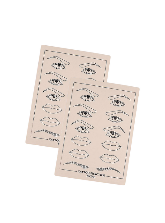 Two sheets of tattoo practice skin with line drawings of eyes and lips on a light gray background.