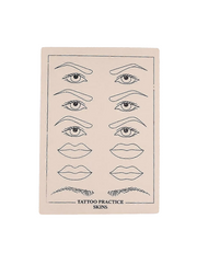 Sheet of tattoo practice skins with line drawings of eyes, lips, and eyebrows on a beige background.