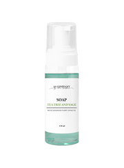 White bottle of soap with a green label on a light gray background tea threee green soap for tattoo and pmu