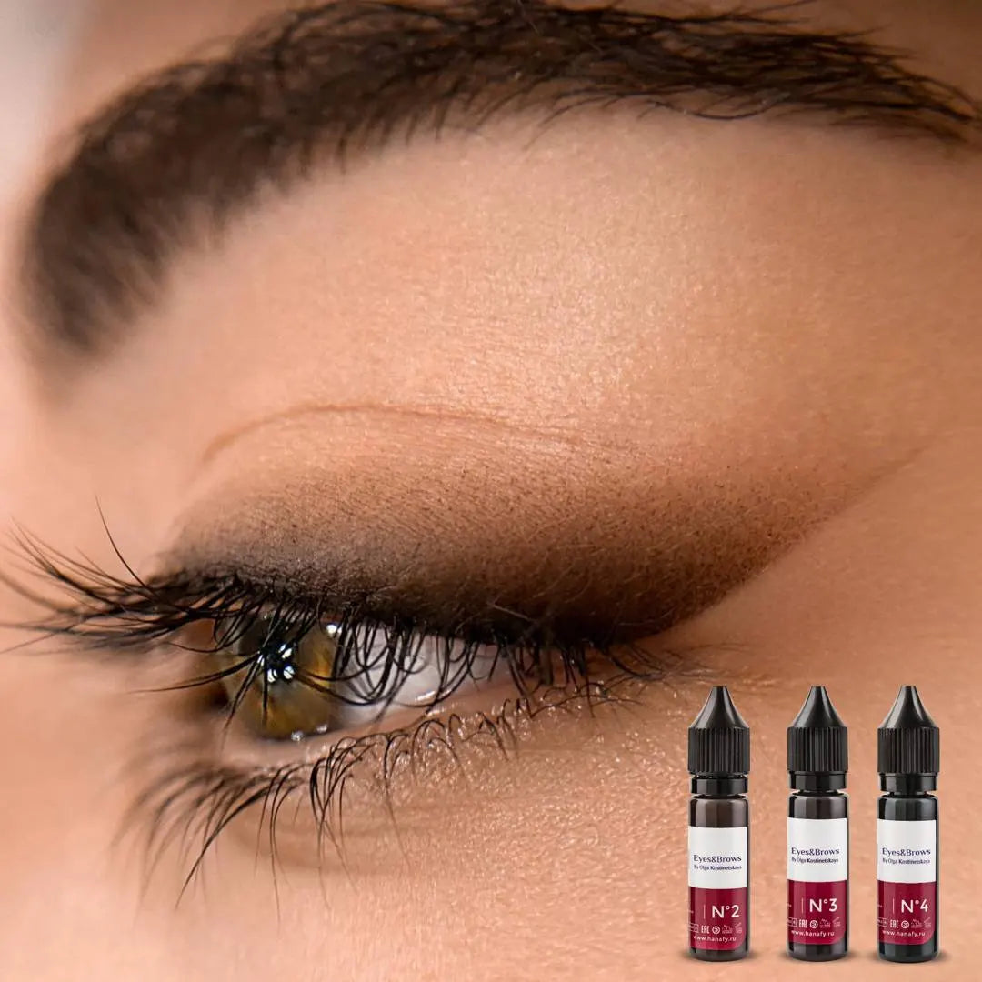Close-up of an eye with eyeliner permanent makeup and four hanafy eyeliner brows pigments on a beige background.